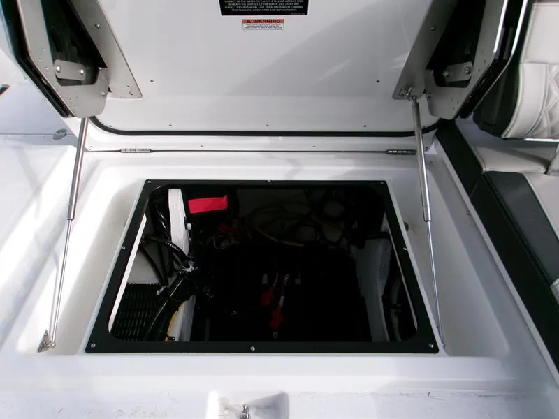 Slide: The Image of 2025 Monterey Elite 27 OB boat storage compartment with open hatch and visible interior components. - 3