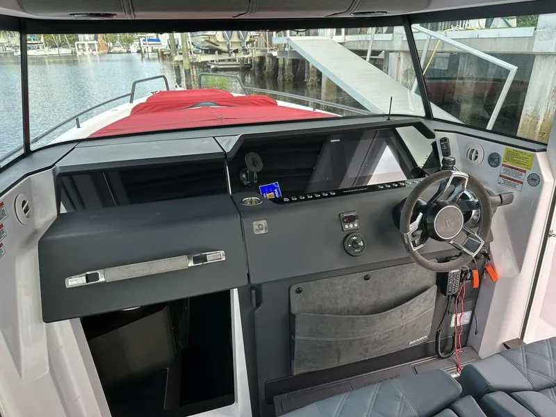 Slide: The Image of 2022 Axopar 37 XC CROSS CABIN interior with modern dashboard and steering wheel. - 10