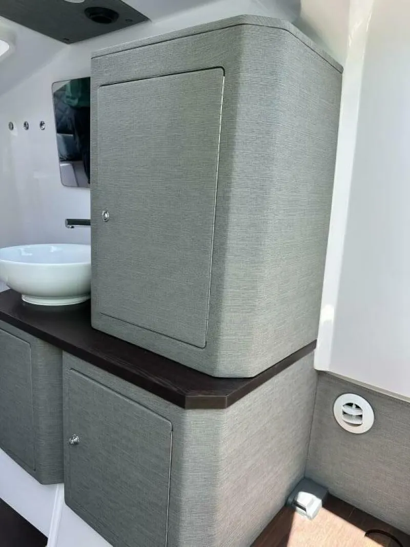 Slide: The Image of 2022 Axopar 37 XC CROSS CABIN interior with modern cabinetry and sink. - 14