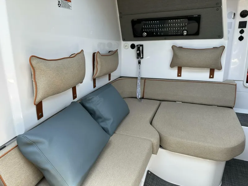 Slide: The Image of 2022 Axopar 37 XC CROSS CABIN interior with cushioned seating and modern design. - 15