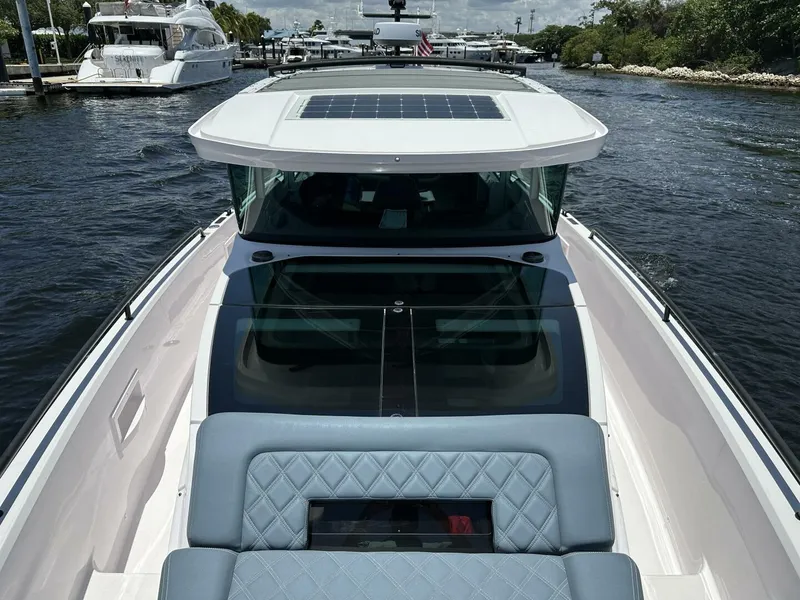 Slide: The Image of 2022 Axopar 37 XC CROSS CABIN boat on water, featuring sleek design and spacious seating. - 18