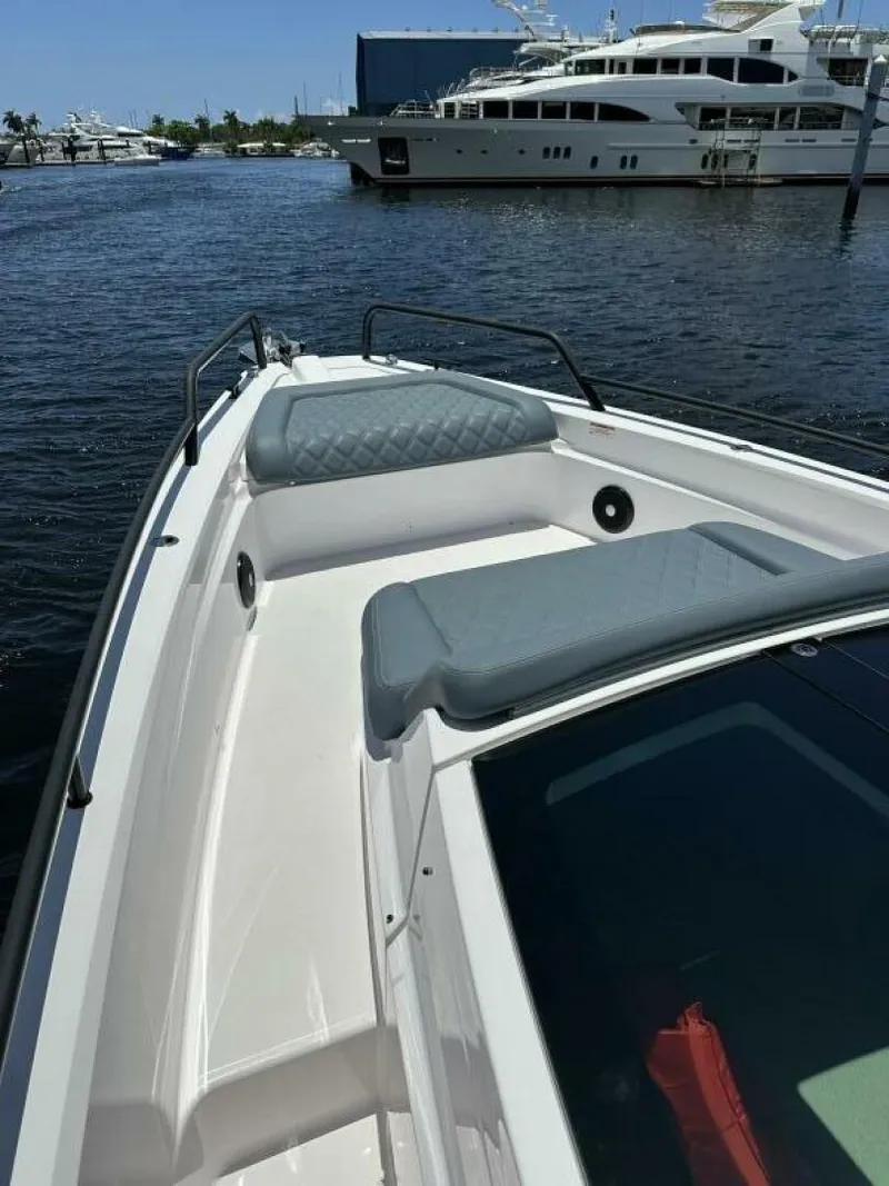 Slide: The Image of 2022 Axopar 37 XC CROSS CABIN boat docked in marina, featuring sleek design and spacious deck. - 19