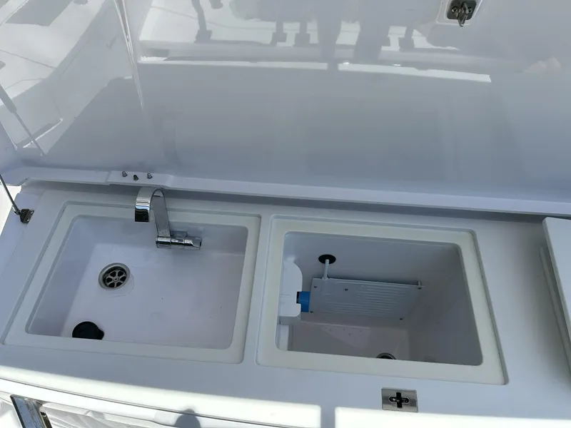 Slide: The Image of Axopar 37 XC CROSS CABIN 2022 boat sink and storage compartments. - 8