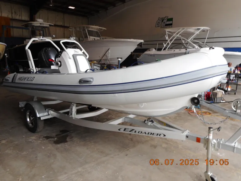 The Image of 2025 Highfield Classic 420 boat on trailer in indoor storage facility. - 0