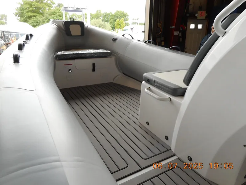 Slide: The Image of 2025 Highfield Classic 420 boat interior with seating and deck, docked in a marina. - 2