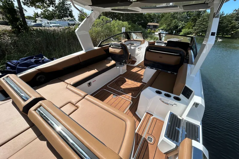 Slide: The Image of 2026 Cobalt R31 boat cruising on calm water, featuring sleek design and modern amenities. - 10
