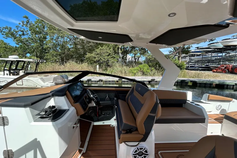 Slide: The Image of 2026 Cobalt R31 boat on calm blue water, featuring luxurious seating and sleek design. - 14