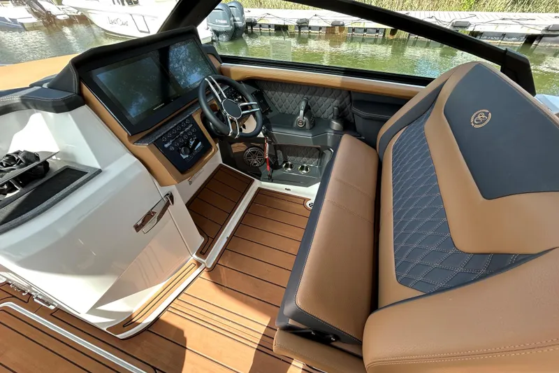 Slide: The Image of 2026 Cobalt R31 boat with tan seating and teak deck on open water. - 15