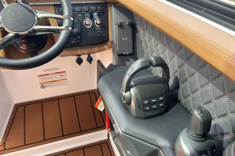 Slide: The Image of 2026 Cobalt R31 boat with luxurious tan seating on a calm lake. - 17