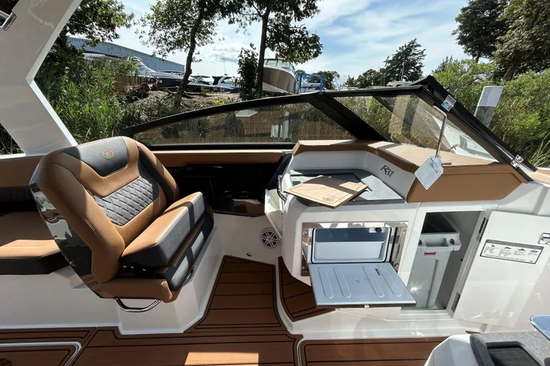Slide: The Image of Luxurious interior of 2026 Cobalt R31 boat with tan seating and wood flooring. - 18