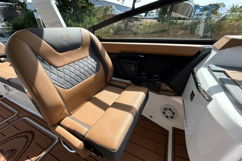 Slide: The Image of Luxurious 2026 Cobalt R31 boat interior with tan seating and sleek design on open water. - 19