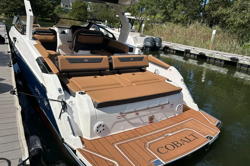 Slide: The Image of 2026 Cobalt R31 boat cruising on water, featuring sleek design and spacious seating. - 2