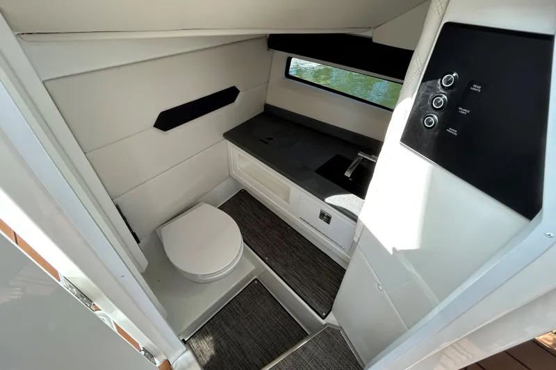 Slide: The Image of 2026 Cobalt R31 boat interior with luxurious seating and modern dashboard on open water. - 21