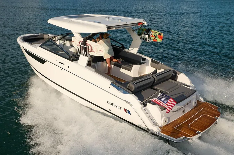 Slide: The Image of 2026 Cobalt R31 boat interior with luxurious seating on a serene lake. - 28