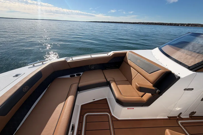 Slide: The Image of Luxurious seating on 2026 Cobalt R31 boat, overlooking serene water and clear sky. - 31
