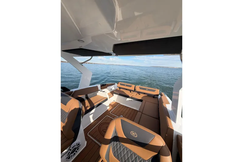 Slide: The Image of Luxurious interior of 2026 Cobalt R31 boat with brown seating and scenic water view. - 34