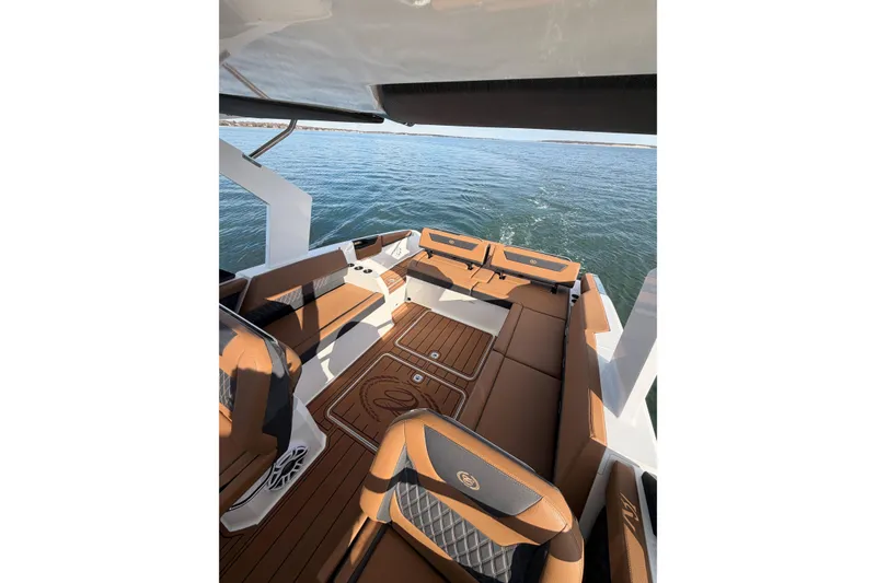 Slide: The Image of Luxurious interior of 2026 Cobalt R31 boat with brown seating and wood flooring. - 35