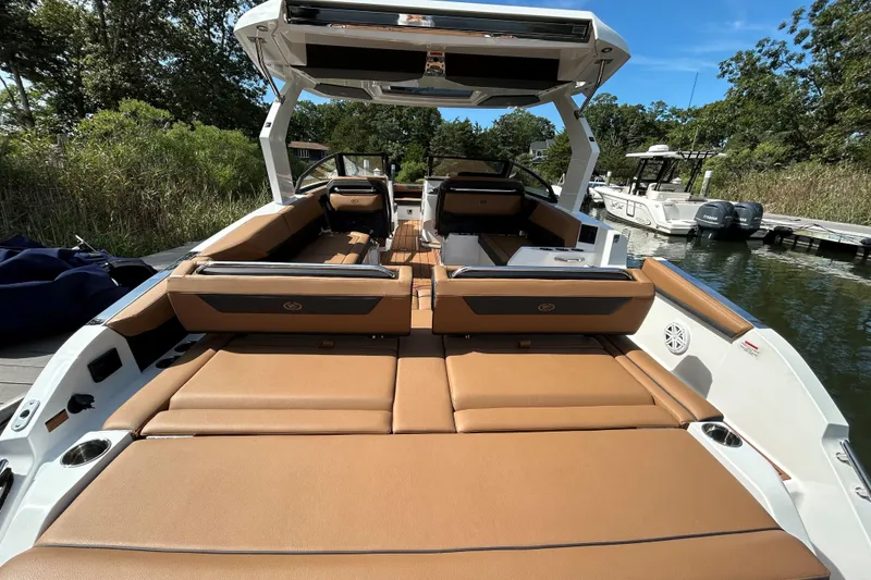 Slide: The Image of 2026 Cobalt R31 boat cruising on calm water, featuring sleek design and spacious seating. - 5