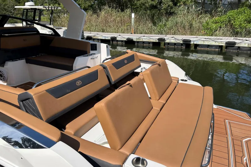 Slide: The Image of 2026 Cobalt R31 boat with sleek design and spacious seating on calm water. - 8