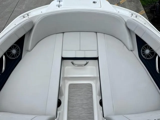 Slide: The Image of 2023 Sea Ray SPX 210 OB boat interior with white cushioned seating. - 10