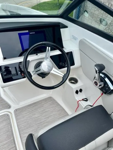 Slide: The Image of 2023 Sea Ray SPX 210 OB boat cockpit with steering wheel and control panel. - 11