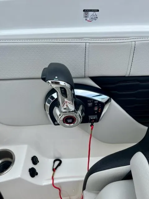Slide: The Image of 2023 Sea Ray SPX 210 OB throttle control with sleek design and ergonomic handle. - 12