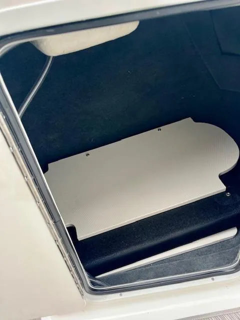 Slide: The Image of 2023 Sea Ray SPX 210 OB storage compartment with white cover. - 13