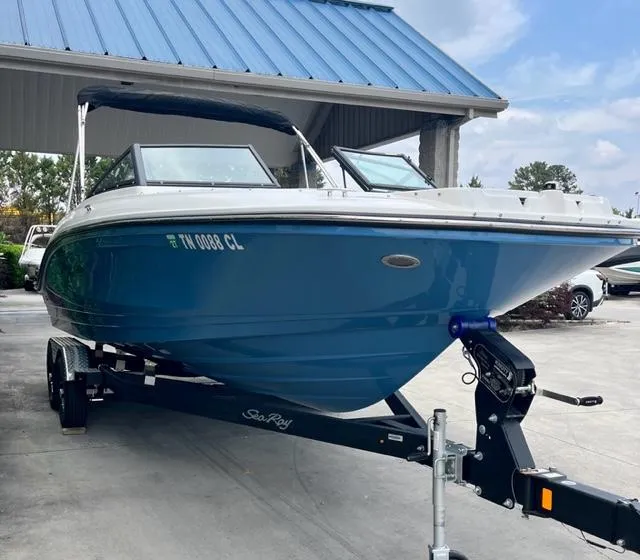 Slide: The Image of 2023 Sea Ray SPX 210 OB boat on trailer under blue roof. - 4