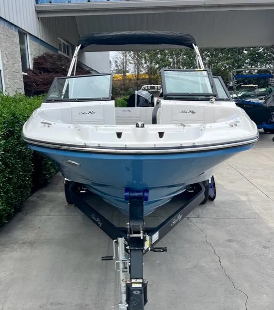 Slide: The Image of 2023 Sea Ray SPX 210 OB boat on trailer, front view, parked outdoors. - 5
