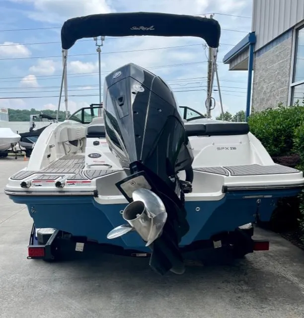 Slide: The Image of 2023 Sea Ray SPX 210 OB boat, rear view, with outboard motor and canopy. - 6