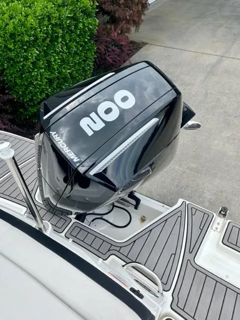 Slide: The Image of 2023 Sea Ray SPX 210 OB boat with Mercury outboard motor, docked on a stylish deck. - 7