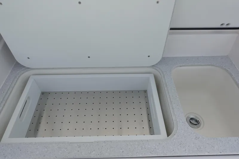 Slide: The Image of 2025 Sea Fox 328 Commander boat sink and storage compartment detail. - 17