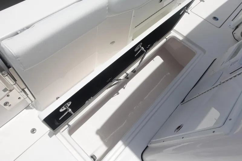 Slide: The Image of 2025 Sea Fox 328 Commander boat storage compartment with open lid, showcasing spacious interior. - 19