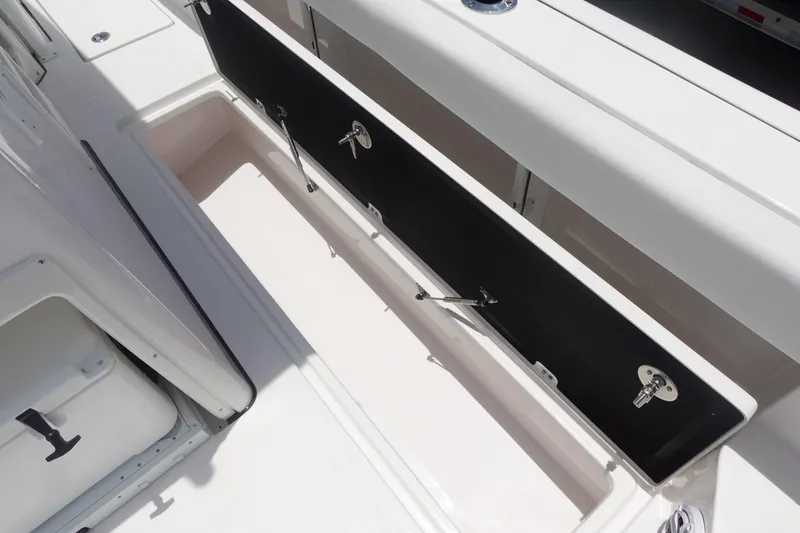 Slide: The Image of 2025 Sea Fox 328 Commander boat storage compartment, open with secure latches. - 20
