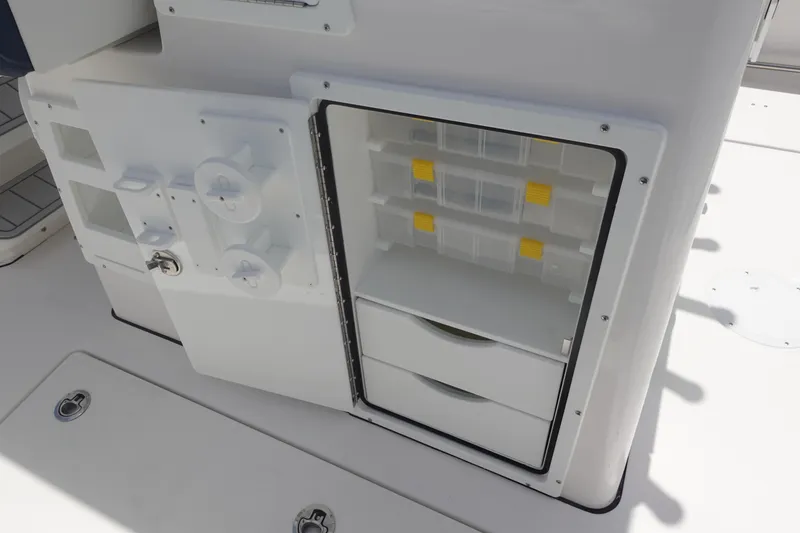 Slide: The Image of 2025 Sea Fox 328 Commander storage compartment with organized shelves and drawers. - 24