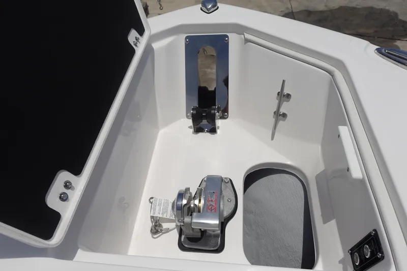 Slide: The Image of 2025 Sea Fox 328 Commander anchor compartment with winch and storage. - 26