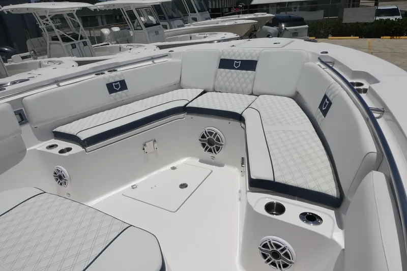 Slide: The Image of 2025 Sea Fox 328 Commander boat interior with cushioned seating and built-in speakers. - 3