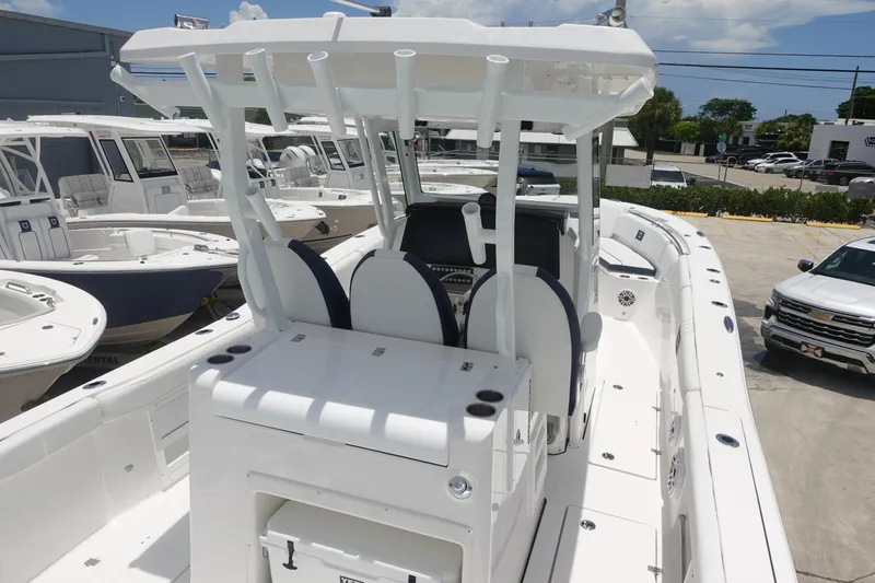 Slide: The Image of 2025 Sea Fox 328 Commander boat with dual seating and T-top in a marina setting. - 31
