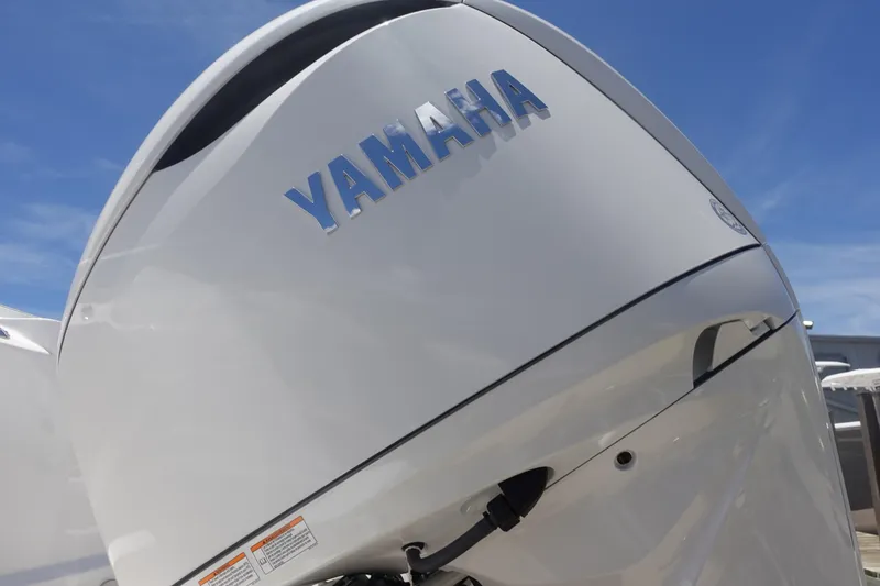 Slide: The Image of Yamaha outboard motor on 2025 Sea Fox 328 Commander boat, under clear blue sky. - 37