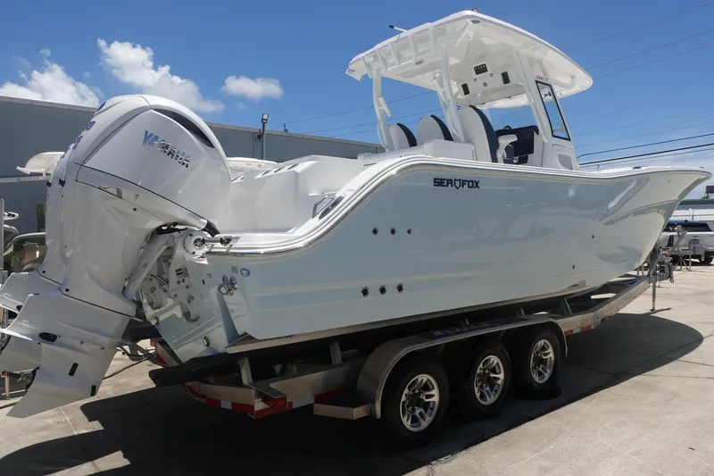 Slide: The Image of 2025 Sea Fox 328 Commander boat on trailer, featuring twin engines and sleek design. - 38