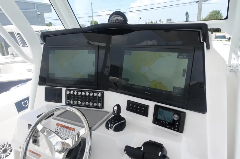 Slide: The Image of 2025 Sea Fox 328 Commander dashboard with dual navigation screens and controls. - 7