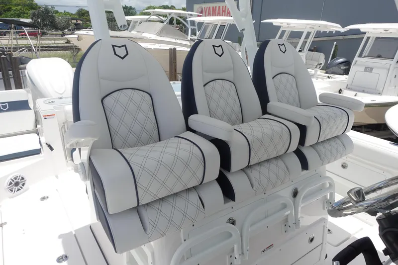 Slide: The Image of Luxury seating on 2025 Sea Fox 328 Commander boat, featuring elegant white and black upholstery. - 8