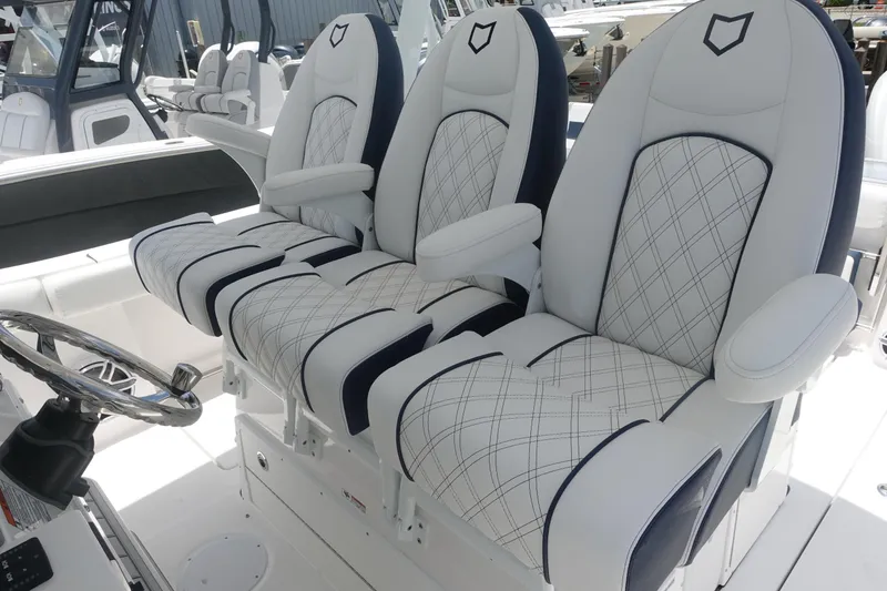 Slide: The Image of 2025 Sea Fox 328 Commander boat seats with elegant diamond stitching and armrests. - 9