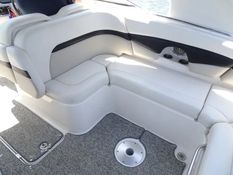 Slide: The Image of 2014 Chaparral 287 SSX boat interior with white seating and gray carpet. - 10