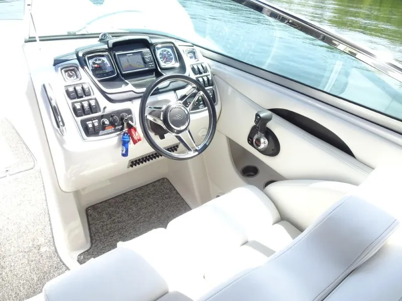 Slide: The Image of 2014 Chaparral 287 SSX boat cockpit with steering wheel and control panel. - 13