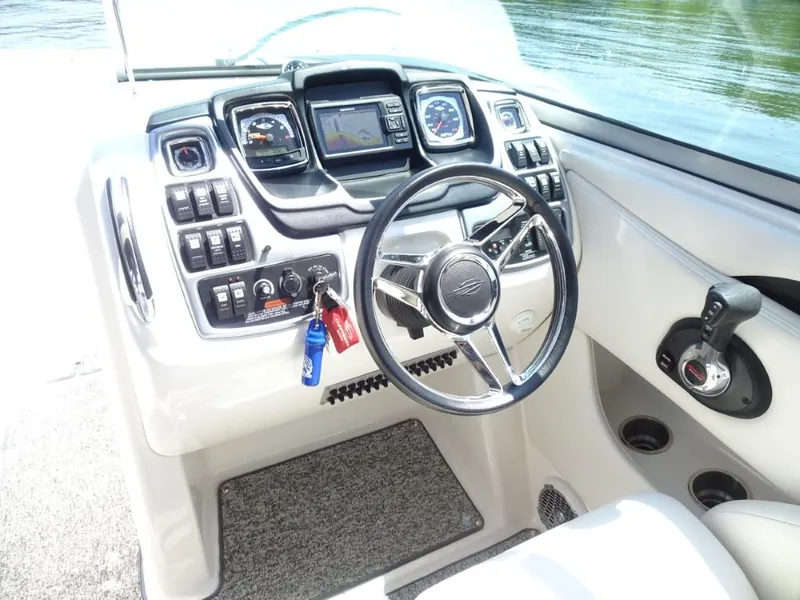 Slide: The Image of 2014 Chaparral 287 SSX boat dashboard with steering wheel and control panel. - 14