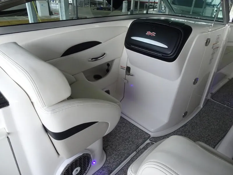 Slide: The Image of 2014 Chaparral 287 SSX boat interior with white seating and modern dashboard. - 17