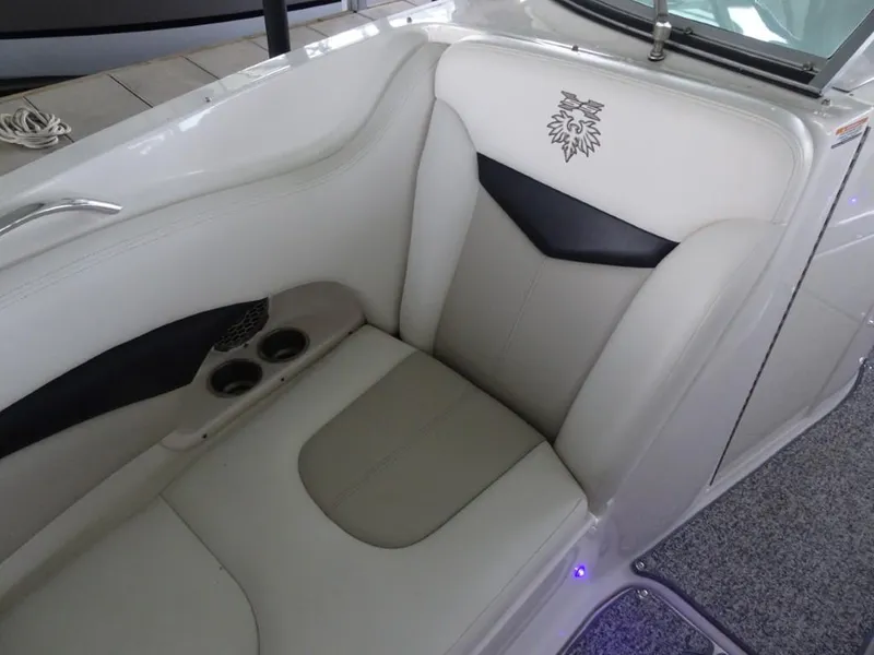 Slide: The Image of 2014 Chaparral 287 SSX boat interior with white leather seating and cup holders. - 23