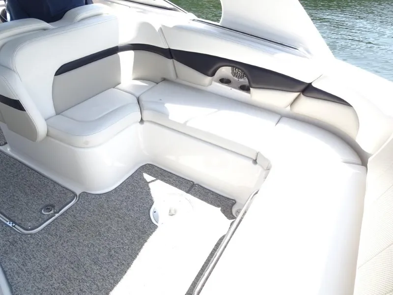 Slide: The Image of 2014 Chaparral 287 SSX boat interior with white seating and gray carpet. - 9