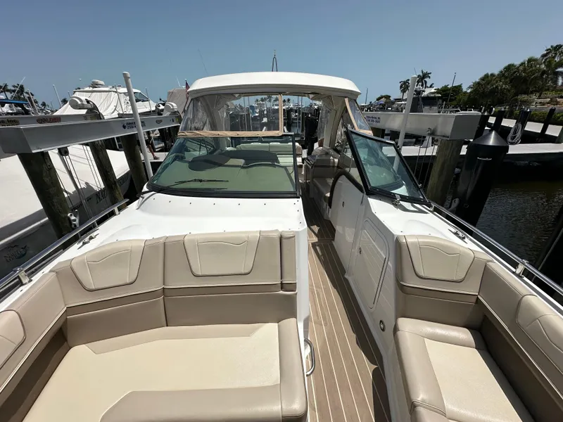 Slide: The Image of 2019 Formula 350 Crossover Bowrider at marina, featuring spacious seating and sleek design. - 10